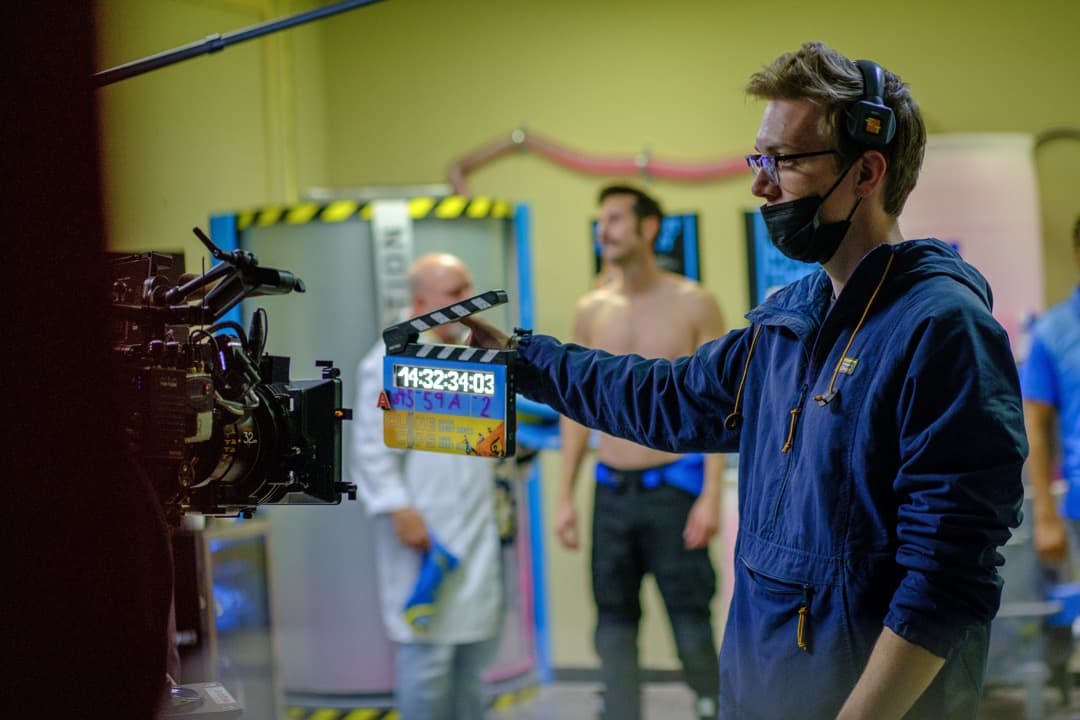 Behind the scenes photo 73 from Clone Cops production showing 2nd ac david king prepares to slate a shot for clone cops